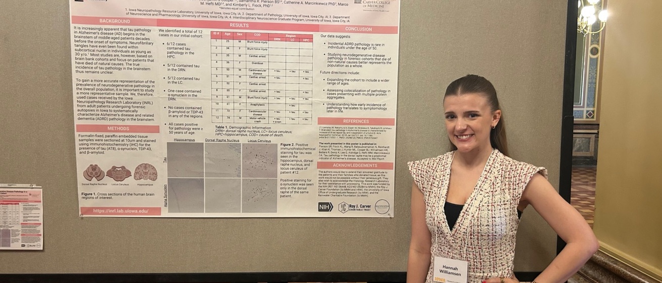 Hannah standing near her research poster